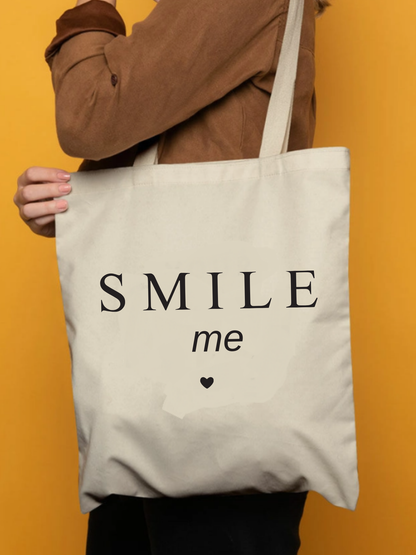 Smile Me tasarımlı %100 pamuk ham bez çanta. 35x40 cm dayanıklı, çevre dostu, günlük kullanım ve hediye için ideal tote bag modeli.